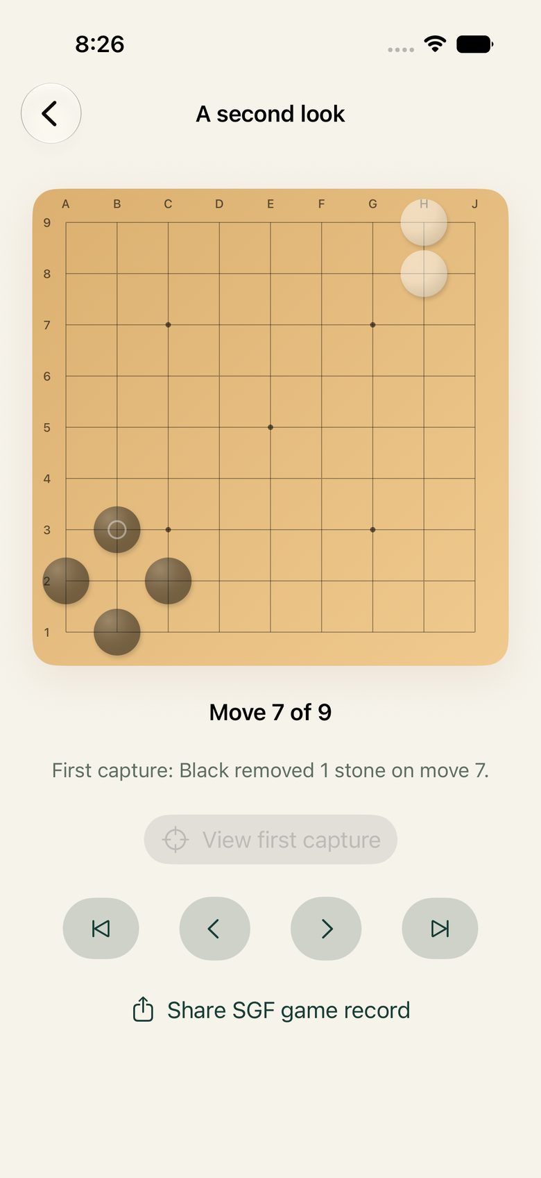 Go Garden replay view titled 'A second look', showing a 9×9 board at move 7 of 9 with the first capture highlighted and a Share SGF control